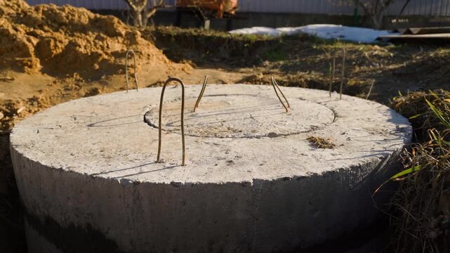 Freshly installed concrete rings and manhole cover for private sewage system