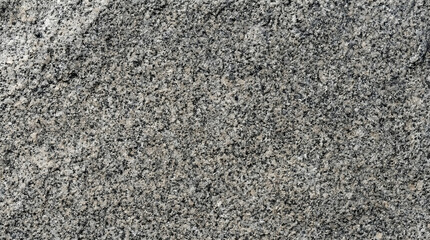 Obraz premium Detailed close-up captures the rugged beauty of granite, showcasing its unique grain patterns and subtle color variations, ideal for design elements.