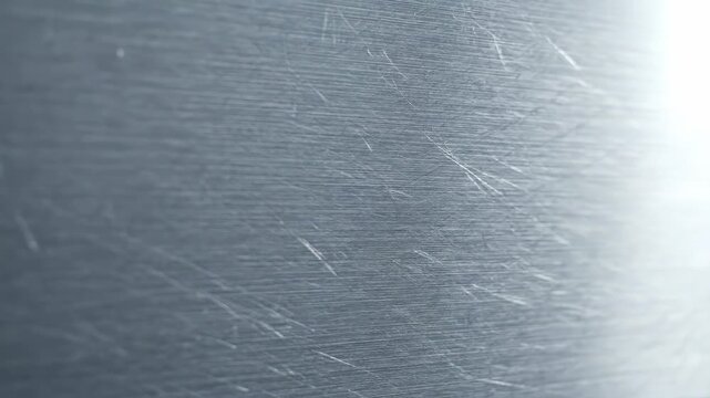 Video of Brushed Metal Surface \'96 Horizontal steel grain pattern, industrial texture background, modern metallic design, sleek silver surface for technology and manufacturing visuals.