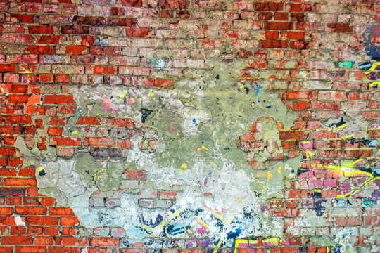  Abstract image of crumbling graffiti on a city street wall. Colorful abstract background. Old, cracked, peeling paint on the wall serves as a backdrop.