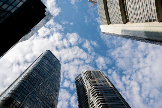 Urban corporate Frankfurt Germany skyscraper architecture with modern glass tower under blue sky and dramatic clouds for business city backdrop