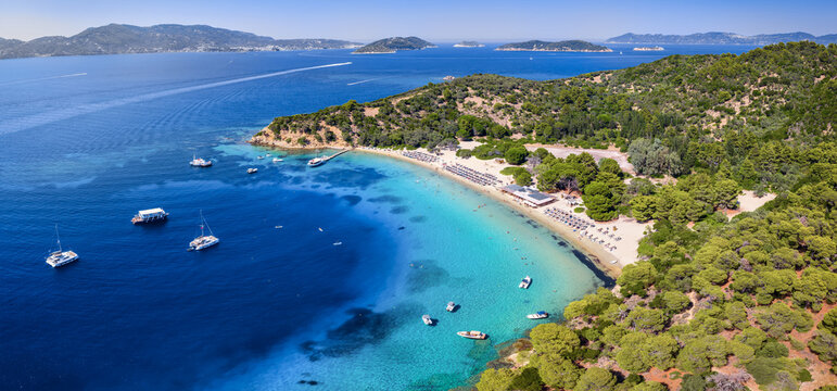 Panoramic aerial view of the pristine beach and turquoise sea at Tsougrias island close to  Skiathos town, Sporades, Greece