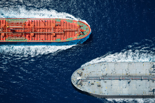 Aerial overhead view of two large crude oil tanker crossing the ocean as a concept for industrial transport