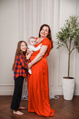 Family portrait with mother and two children in a home setting