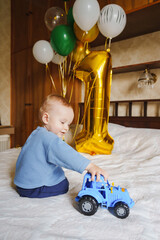 Celebrating a child's first birthday with balloons and toys