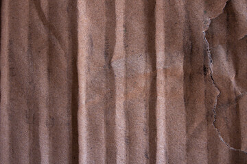 Fototapeta premium Torn Corrugated Cardboard Texture with Vertical Ridges and Rough Edge