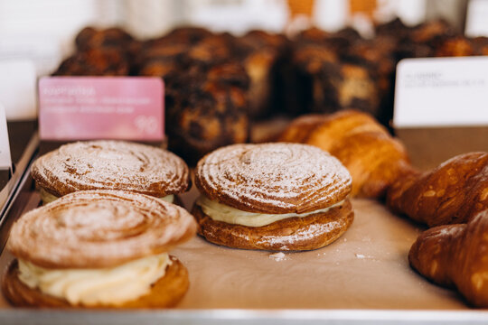 Close up of Paris-Brest pastry on bakery display shelf.