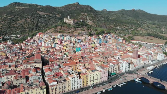 Aerial: Drone Pulling Back from Serravalle Castle and Colorful Bosa, Sardinia, Italy
