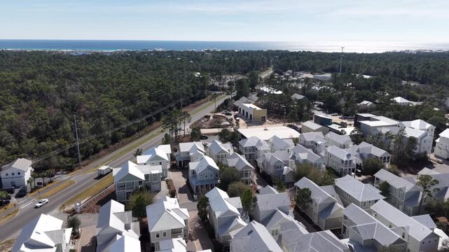 Upward drone fly over a coastal residential area with newly built white houses, 30A, Florida, USA