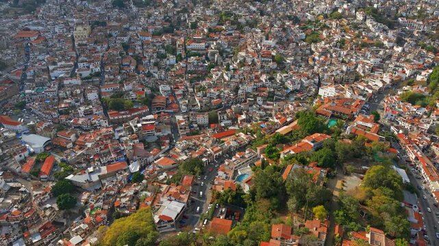 Aerial view of the city of Taxco, colonial architecture with white houses and tiled roofs nestled among mountains, Guerrero, Mexico