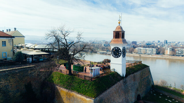 Aerial view of the iconic clock tower standing proudly atop the Petrovaradin Fortress, overlooking the serene Danube River, Petrovaradin, Vojvodina, Serbia.
