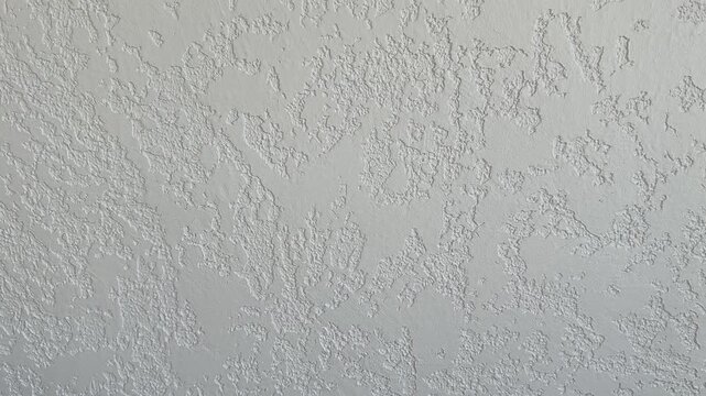 White plaster wall background with rough irregular texture