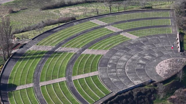 Aerial view of rows of white crosses and green grass in the cemetery, a somber yet structured landscape, Mittelwihr, Grand Est, France.