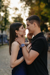 Obraz premium Close up portrait of an attractive young couple looking into each other's eyes with love on a city street