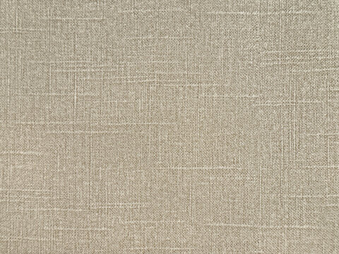 Close up of light beige linen fabric or leather, seamless background texture.
