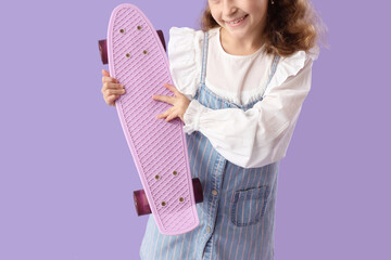 Cute little girl with skateboard on lilac background, closeup © Pixel-Shot