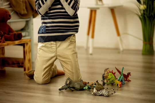 Little toddler child, boy,  pee in his pants while playing with toys, child distracted and forget to go to the toilet