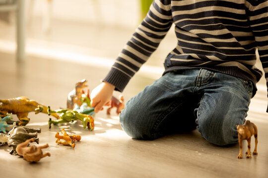 Little toddler child, boy,  pee in his pants while playing with toys, child distracted and forget to go to the toilet