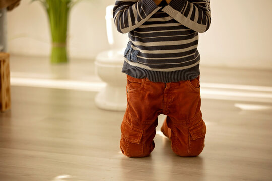 Little toddler child, boy,  pee in his pants while playing with toys, child distracted and forget to go to the toilet