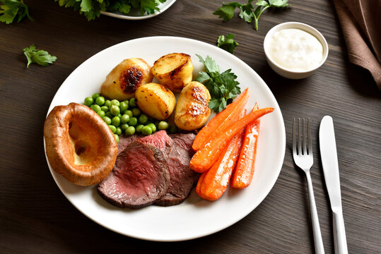 Sunday Roast with roasted beef, carrots, crispy potato, green pea and yorkshire pudding