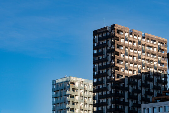 Daylight skyline of modern residential apartment buildings in Bjorvika Oslo with contemporary architecture rising above the city under clear blue sky