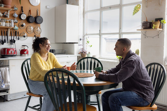 Young friends chatting in a cosy kitchen setting