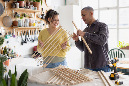 Friends assembling a piece of flat pack furniture together