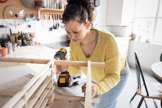 Woman Focused on DIY Project in Cozy Home Setting