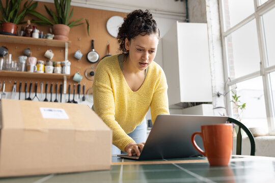 Focused Woman getting a parcel ready to ship