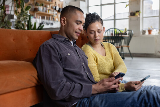 Couple Engaged in Phone Activity Together at Home