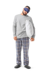 Fototapeta premium Male sleepwalker in pajamas with pillow on white background
