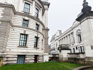 Naklejka premium Historic neoclassical Churchill War Rooms government building architecture in London UK with ornate stone facade and curved corner