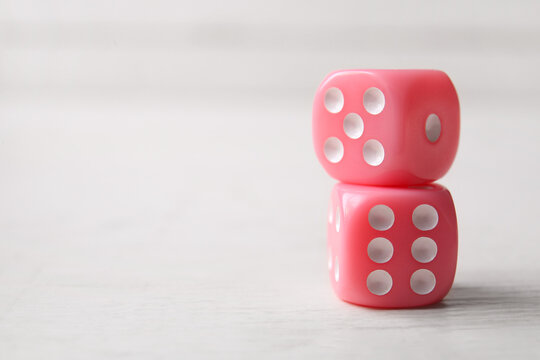 Pink game dices on white background