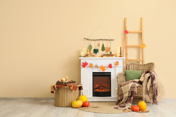 Naklejka premium Interior of living room with fireplace, armchair and autumn decor