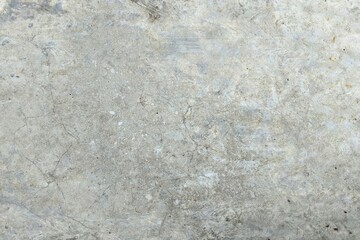 Obraz premium Polished gray concrete wall texture with subtle cracks and weathered industrial finish. Seamless cement floor background for architectural design, grunge backdrop, or urban construction concept.