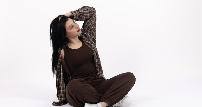 Woman sitting cross-legged on the floor and looking up