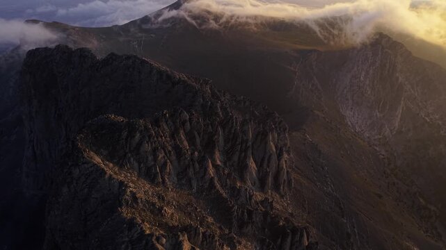 Aerial view of the rugged, towering peaks of Mount Olympus, where light and shadow create contrast, Larissa, Greece.