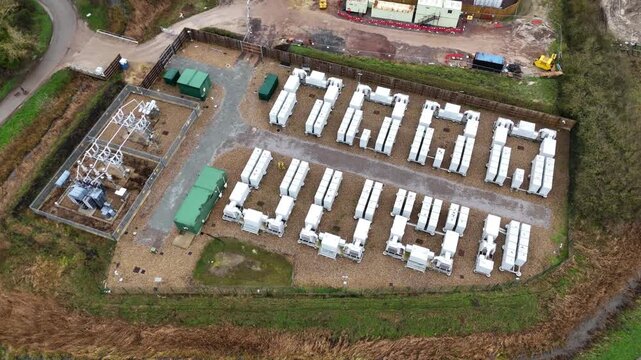 Aerial view of electrical substation, solar panels, battery energy storage systems and green containers, Burwell, United Kingdom.