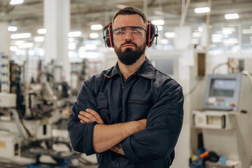 Fototapeta premium In protective headphones. Warehouse worker in an industrial environment of a factory or storage area