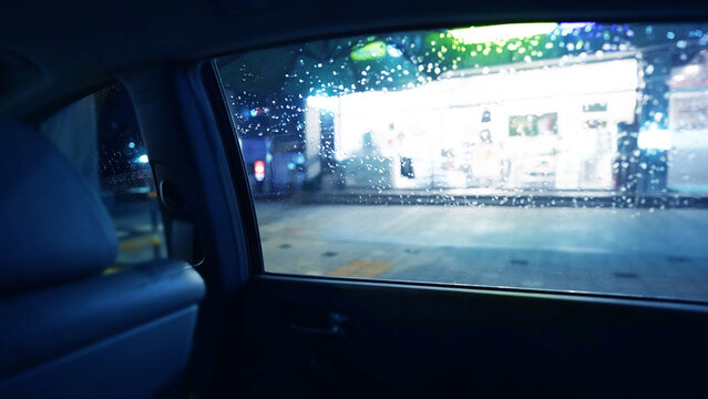 Rainy Night View through Car Window with Bokeh City Lights