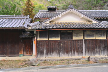 日本の原風景：田舎の静かな道と古い橋、伝統的な家屋が並ぶノスタルジックな風景 © taka