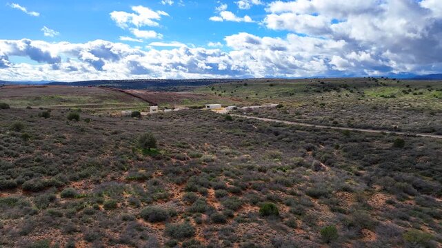 Aerial view of the expansive WM - Gray Wolf Regional Landfill with a road cutting through the arid landscape, Dewey, Arizona, United States.