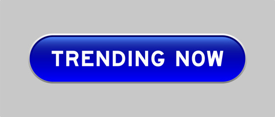 Fototapeta premium Blue color capsule shape button with word trending now on gray background