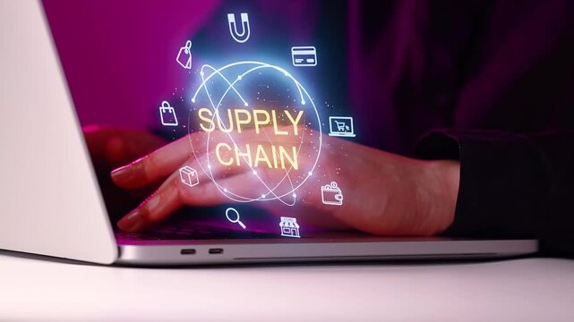 Hands typing on laptop with supply chain graphic showing focus on logistics and technology in a workspace setting.