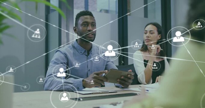 Colleagues discussing business strategy in modern conference room, with floating network icons
