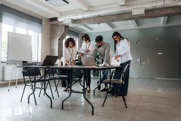 Fototapeta premium Natural lighting. Group of people are working in the office together as a team