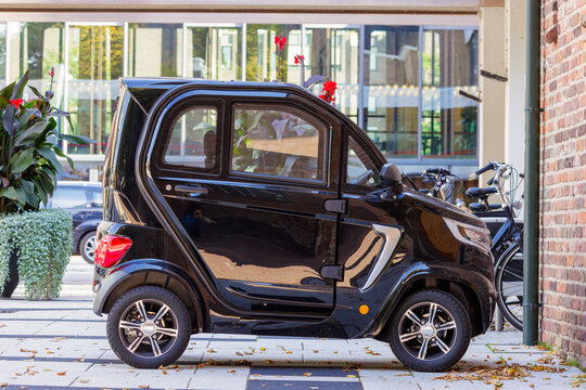 Parked electric micro car in a city center