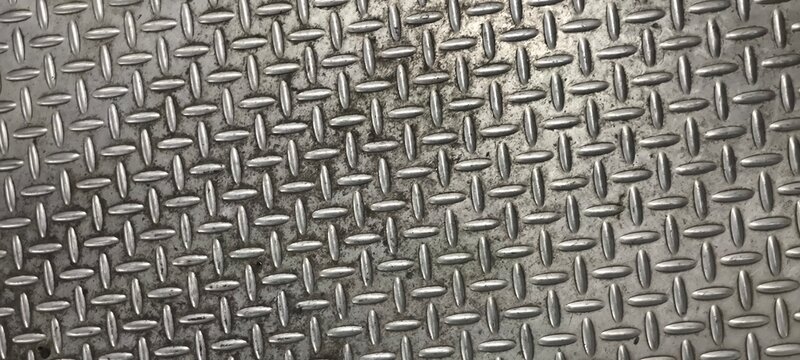 The diamond plate  also known as tread plate or checkered steel plate. which is a type of metal stock with a regular pattern of raised diamonds or lines on one side.