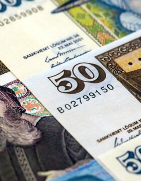 Icelandic krona money bills pile on table. Iceland banknotes of ISK currency close up. Concept of business, economy and banking in Iceland