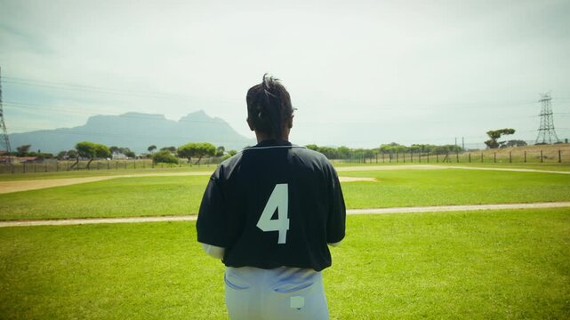Pitcher practices throwing on the baseball field